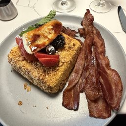 Crunchy French toast with a side of bacon. I tried to eat it all, but it was so filling. The bacon was epic. Crunchy French toast with a side of bacon. I tried to eat it all, but it was so filling. The bacon was epic.