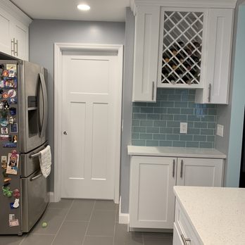 Jmac Contractors LLC - a kitchen with white cabinets and a stainless steel refrigerator - General Contractors Near Me - Brick, New Jersey