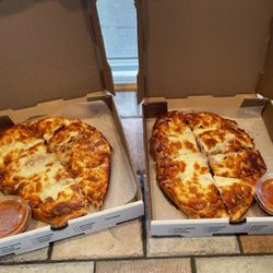 Ware House of Pizza - Two calzones one meat lovers and one Outback with lid open.