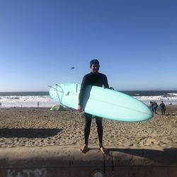 Sonlight Surfshop - Surfboard and beach next to surf shop