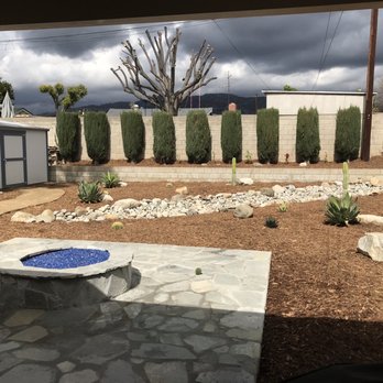 Juca Contractors - a view of a backyard with a fire pit - General Contractors Near Me Juca Contractors - a view of a backyard with a fire pit - General Contractors Near Me