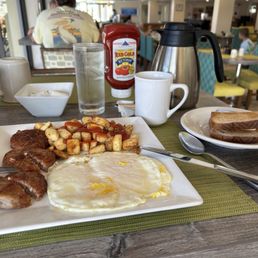 Two eggs over easy sausage patties, home fries and wheat toast + a pot of coffee