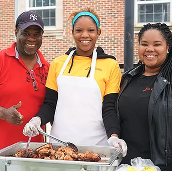 Da Taste Take Out - a man and two women holding a tray of food - Caribbean Near Me - Oshawa, Ontario