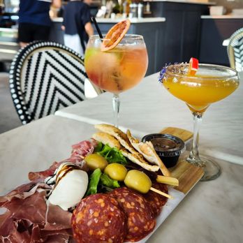 Mangoni - Charcuterie board, white sangria and peach bellini. - Pizza Near Me - Winter Garden, Florida