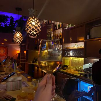 Margot Natural Wine - a person holding a glass of wine - Wine Bars Near Me - Miami, Florida Margot Natural Wine - a person holding a glass of wine - Wine Bars Near Me - Miami, Florida