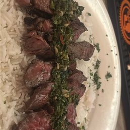 Hanger steak over rice with a chimichuri sauce Hanger steak over rice with a chimichuri sauce