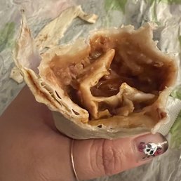 Bean burrito. The red sauce and bits of raw onion are the best. Bean burrito. The red sauce and bits of raw onion are the best.