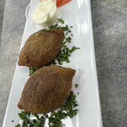Kibbeh with dipping sauce Kibbeh with dipping sauce