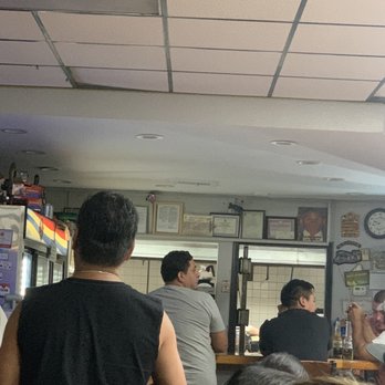 Pupuseria Carmelina - a group of people in a restaurant - Imported Food Near Me - Uniondale, New York Pupuseria Carmelina - a group of people in a restaurant - Imported Food Near Me - Uniondale, New York