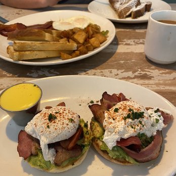 Toast Kitchen & Bar - Classic Benedict with hollandaise on the side (across is husband's simple breakfast - eggs/bacon and half order classic French toast) - Breakfast & Brunch Near Me - Brea, California Toast Kitchen & Bar - Classic Benedict with hollandaise on the side (across is husband's simple breakfast - eggs/bacon and half order classic French toast) - Breakfast & Brunch Near Me - Brea, California
