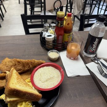 The Kitchen Bar & Grill - My flounder, eggs and grits breakfast. The strawberry mimosa may look funny, but that thing was hitting!!! Hahahaha! - Breakfast & Brunch Near Me - Douglasville, Georgia