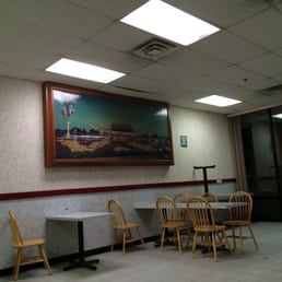 a restaurant with a painting on the wall a restaurant with a painting on the wall