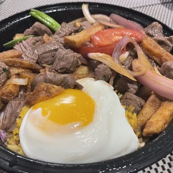 Brisas Latin Cuisine - Lomo saltado - Seared steak, house soy sauce, tomatoes, onions, scallions, fries, one sunny side up egg, and yellow rice - Latin American Near Me - Brookfield, Connecticut