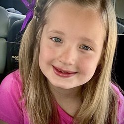Snip-its Haircuts for Kids - After: Layered Trim with braid, bow, glitter and scent mist