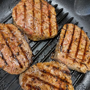 B & E Meats and Seafood - three steaks cooking in a skillet - Butcher Near Me - Seattle, Washington