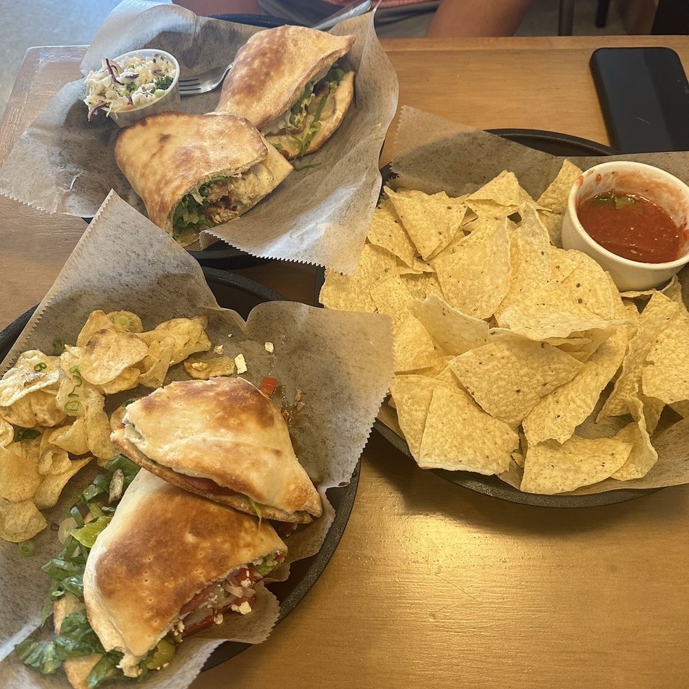 Top left is chicken ceasar sandwich and bottom left is the Greek Sandwich Top left is chicken ceasar sandwich and bottom left is the Greek Sandwich