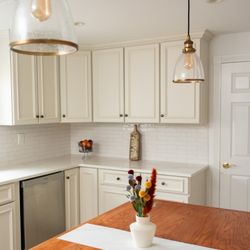 Stone and Tile Design - Thoughtful craftsmanship featuring a custom-built table incorporating the same stone as the countertops as a runner accent.