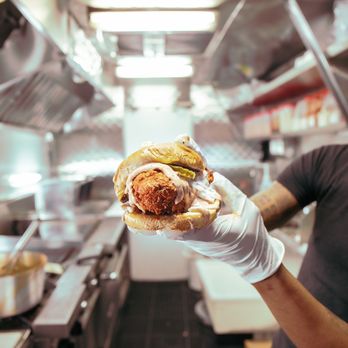 The Chicken Coop - a man holding a sandwich - Food Trucks Near Me The Chicken Coop - a man holding a sandwich - Food Trucks Near Me