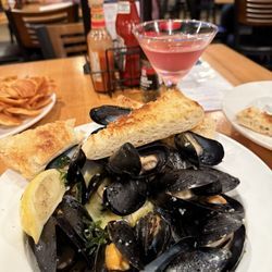 The New England House - Appetizer mussels: sautéed with butter, white wine and garlic plus grilled bread. Delicious! Oh and the drink is a most excellent Cosmo.