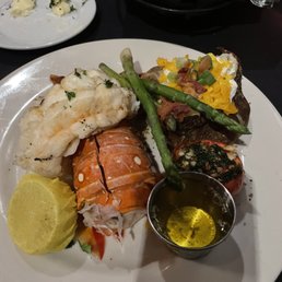 Lobster, baked potato, roasted tomato and asparagus.