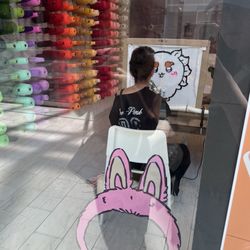 TuTugether - The employee sitting down and working on her OWN run after telling us there is no availability for rug tufting because it's so busy.