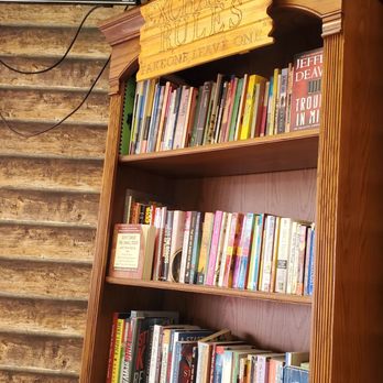 Sand Dust Coffee - a bookshelf with a television in the background - Coffee & Tea Near Me - El Paso, Texas