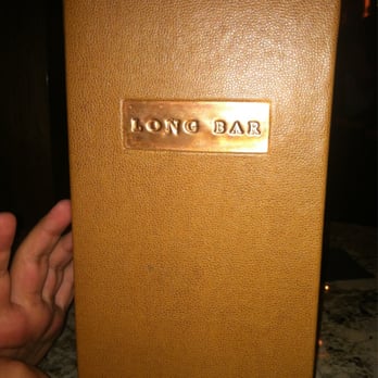 Long Bar - a hand holding a brown leather case - Bars Near Me Long Bar - a hand holding a brown leather case - Bars Near Me