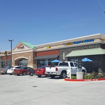 The Sheldon Centre - a parking lot with cars parked in front of it - Gas Stations Near Me - Elk Grove, California