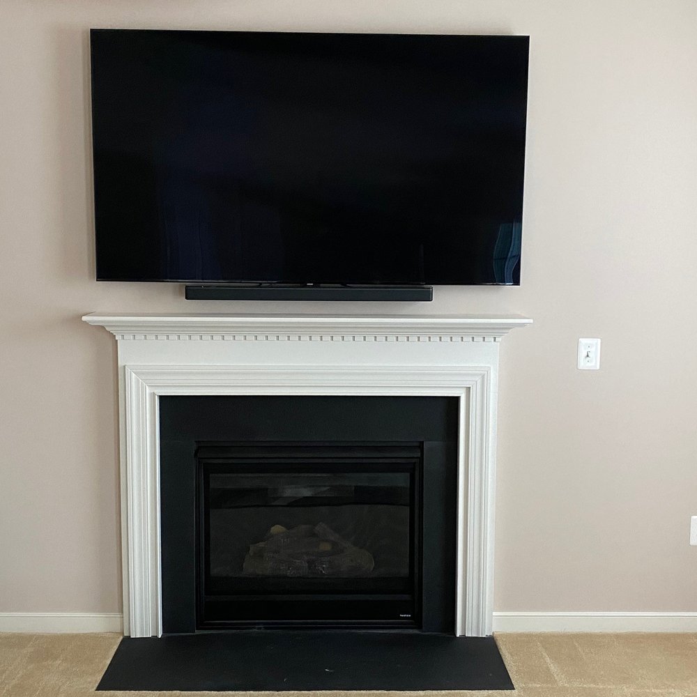 American AV - TV and Soundbar mounted over Fireplace - Home Network Installation Near Me