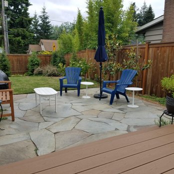 Solid Ground Landscape - A little slice of our wood deck with the stone extension for afternoon relaxation! - Irrigation Near Me - Everett, Washington