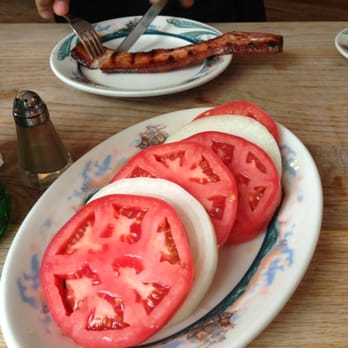 Peter Luger - A side of sliced tomato and onions for two. - Steakhouses Near Me - Brooklyn, New York