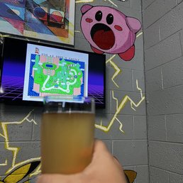 a person holding a glass of beer a person holding a glass of beer