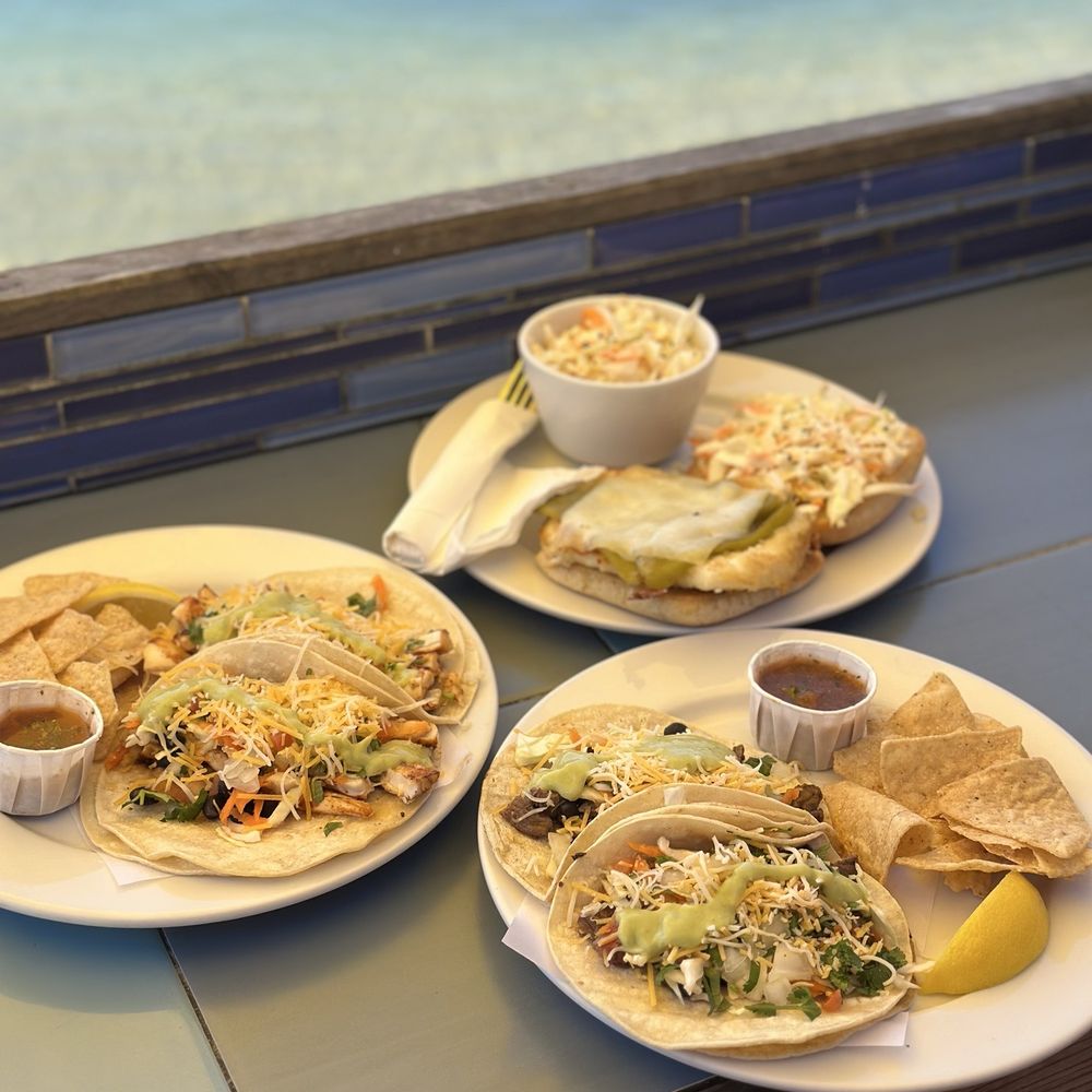 The Sand Bar - Ahi tacos (left), steak tacos (right), calamari sandwich (top) - Cocktail Bars Near Me - Capitola, California The Sand Bar - Ahi tacos (left), steak tacos (right), calamari sandwich (top) - Cocktail Bars Near Me - Capitola, California