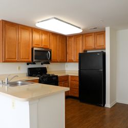 Cascades Overlook Apts - Spacious kitchen at Cascades Overlook with ample cabinet storage, counter space and a breakfast bar in Owings Mills.