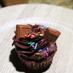 Toni's Tasty Treats - Chocolate cupcake with chocolate buttercream, bite size candy and sprinkles