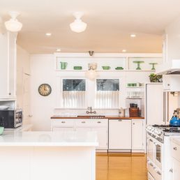 a kitchen with white cabinets and appliances a kitchen with white cabinets and appliances