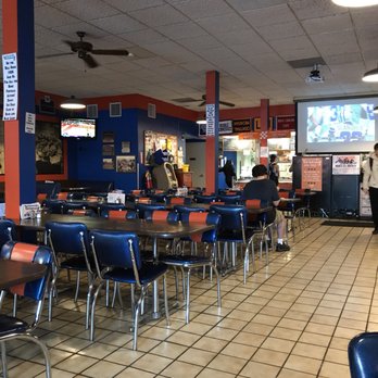 Varsity Pizza - The blue and the orange. The walls are covered with lots of Syracuse Orangemen memorabilia. - Pizza Near Me - Syracuse, New York