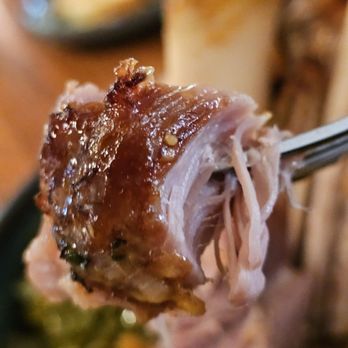 The Pine Room and 1882 Lobby Bar - A fork holding a piece of The Slow Roasted Pork Shank. - Pubs Near Me - Roanoke, Virginia