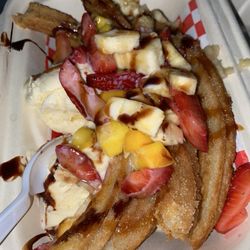 Churros Huesos - Churros w/ mango, strawberry and banana and vanilla ice cream.
