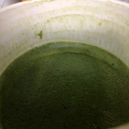 a green drink in a white cup a green drink in a white cup