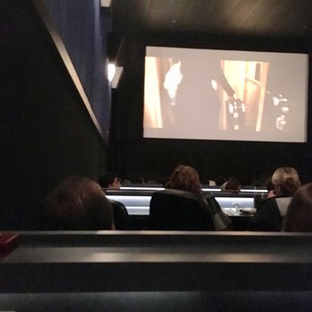 Studio Movie Grill - Showing the seat where you are in front of desk, no lounge seat. - Cinema Near Me - Dallas, Texas