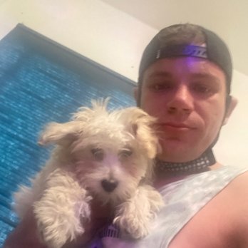 Dick's R U Crazy - a man holding a dog - Gay Bars Near Me - Hammond, Indiana