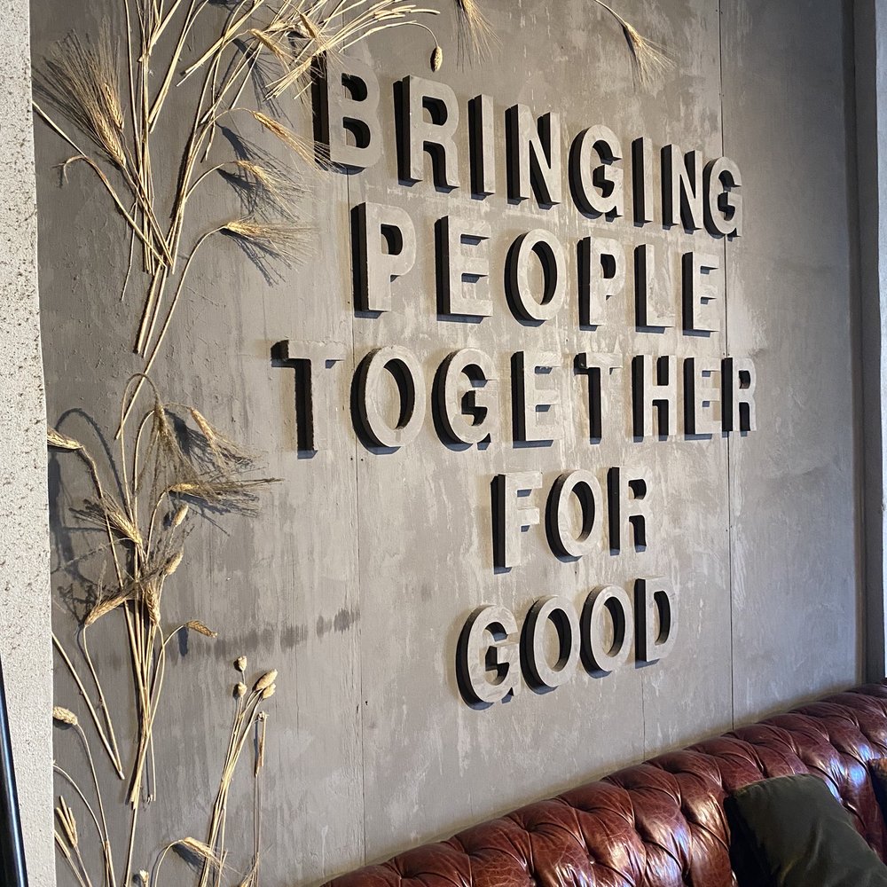 TEN20 - a leather couch with a sign that says bringing people together is for good - Venues & Event Spaces Near Me - Louisville, Kentucky TEN20 - a leather couch with a sign that says bringing people together is for good - Venues & Event Spaces Near Me - Louisville, Kentucky