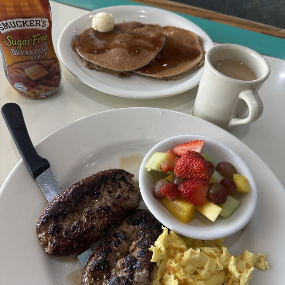 Wheat pancakes with Italian sausage eggs and fruit. Wheat pancakes with Italian sausage eggs and fruit.