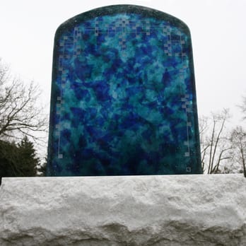 Lundgren Monuments - A crushed blue glass memorial set on white granite. - Funeral Services & Cemeteries Near Me - Seattle, Washington