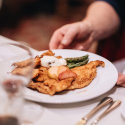 Cedar House Pub - Granlibakken's Chicken Schnitzel - Our chicken is traditionally breaded in house with lemon caper butter, potato pancake, apple compote, veg