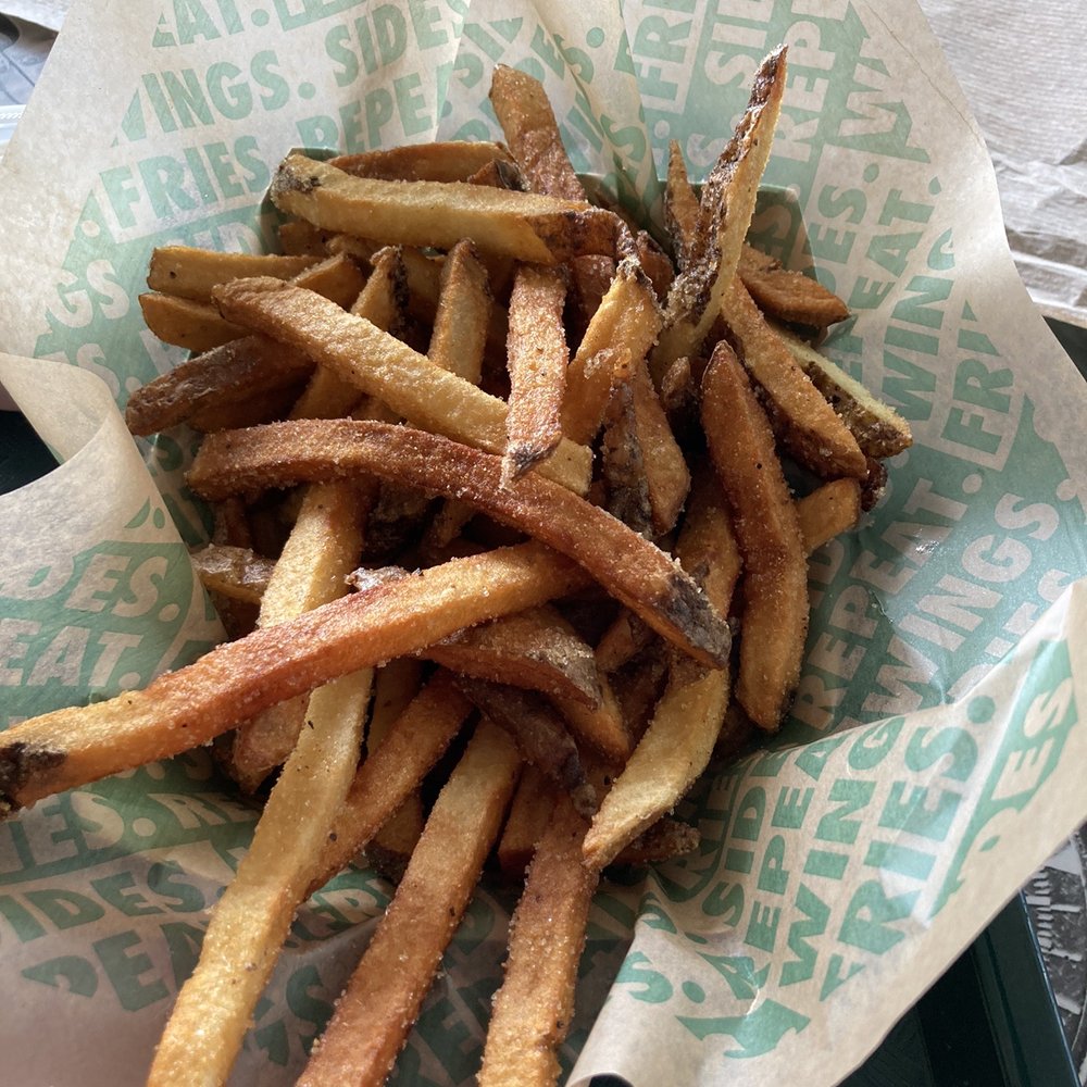 Wingstop - a basket of french fries on a table - Chicken Wings Near Me - Waukesha, Wisconsin Wingstop - a basket of french fries on a table - Chicken Wings Near Me - Waukesha, Wisconsin