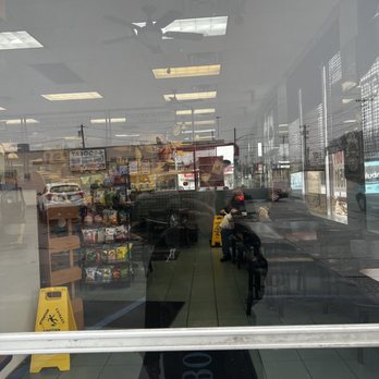 Bagel Boss - Oceanside - the reflection of a man in a store window - Bagels Near Me - Oceanside, New York