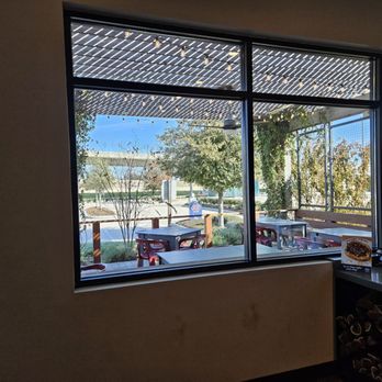 Becks Prime - a view of a patio through a window - American Near Me - Katy, Texas