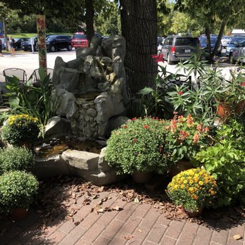Kimmswick - a fountain surrounded by plants and flowers - Town Hall Near Me - Kimmswick, Missouri
